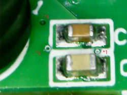 Image of a PCB with two elements marked as vias, possibly bypass capacitors, labeled as *1 and *2.
