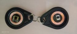 Two key fobs placed close together, showing passive electronics inside.