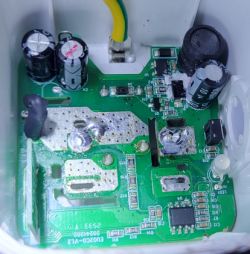 Circuit board with electronic components, capacitors, and a grounding wire