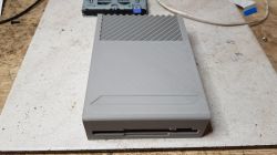 Prototype Floppy Drive Case for Atari Prototype 3'5 inch floppy drive case for Atari with gray diagonal striped pattern.