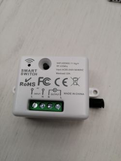 Smart switch with Wi-Fi and RF433 features on a white surface.