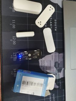 Tuya Smart Door Sensor with parts spread out on a table.