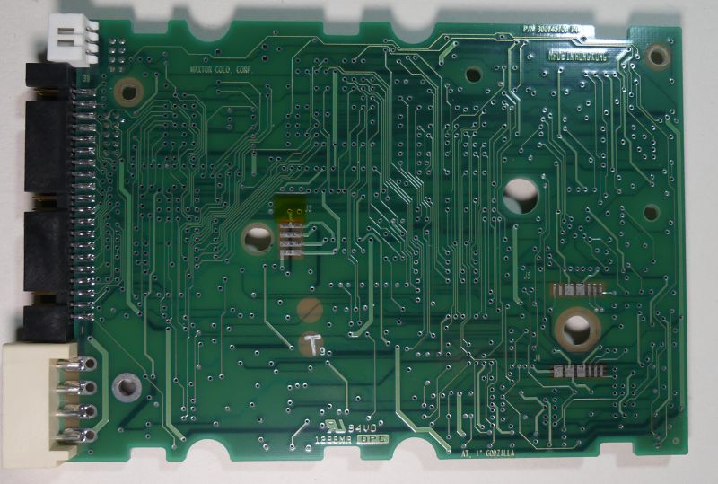 View of the back side of a hard drive PCB with PATA interface, showing traces and contact points without visible electronic components.