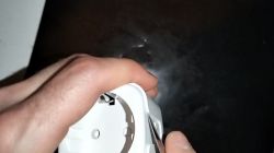 Hand holding a white AUBESS electric socket.