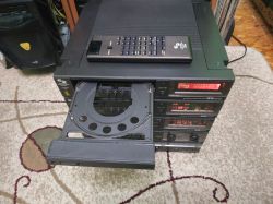 Retro Schneider audio set with an open CD tray and a remote control on top.