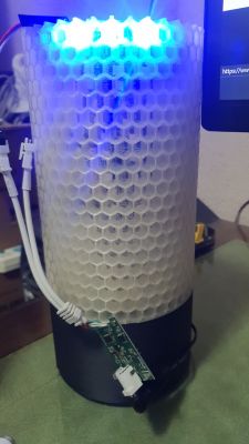 3D-printed lamp with blue lighting and a PCB board.
