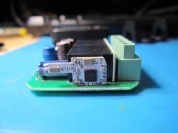 Close-up of an electronic module on a green printed circuit board.