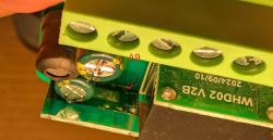 Close-up of PCB with capacitors and screw terminal connector