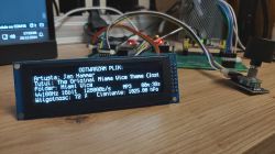 LCD screen displaying audio file playback with metadata.
