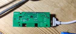 BK7231N Circuit Board with Labeled Ports BK7231N circuit board with labeled ports on a wooden surface.