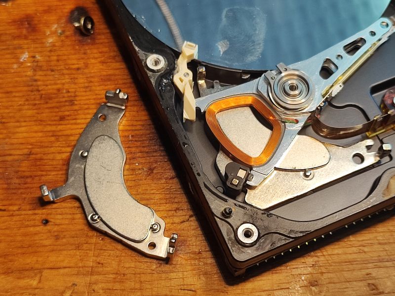 Inside View of HDD Interior of a hard disk drive showing the head and platter.
