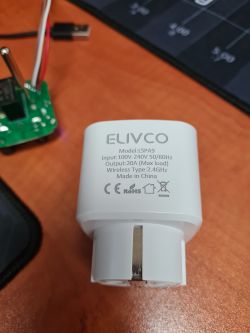 Close-up view of an ELIVCO smart socket with technical specifications.