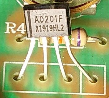 Close-up of electronic components on a green circuit board, including an AO201F transistor and a resistor.