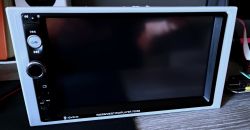 2DIN car stereo with a dark touchscreen and left-side buttons; text “PLAYER 7023B” on the bezel