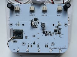 Image of the interior motherboard of a solar-powered siren, featuring an OPL1000 chip on a white board.