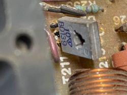 Zbliżenie na potencjometr montażowy 100Ω obok cewki i oznaczenia T211 na płytce PCB