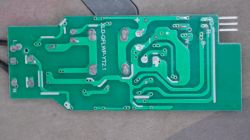 Green PCB underside with traces and solder pads; four-pin header protruding on the right