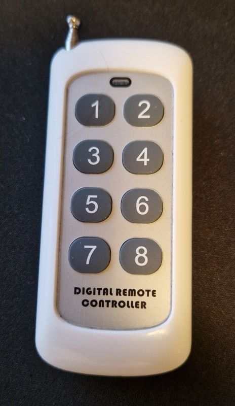 RF remote with 8 numbered buttons and antenna, text reads DIGITAL REMOTE CONTROLLER