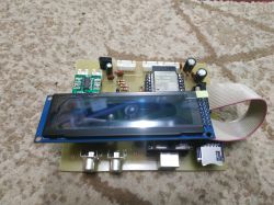 DIY radio on a PCB with a display and connectors.