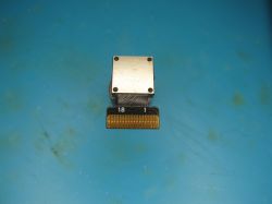 Electronic module with metal shield and contact connector on blue background