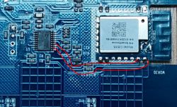 Close-up of a circuit board with a WiFi module and TuyaMCU microcontroller connected via UART bus.