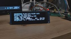 OLED display showing information about a playing music file.