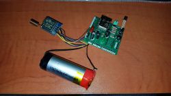Battery and Electronic Circuit from E-Cigarette Battery from a disposable e-cigarette with an electronic circuit on a wooden background.