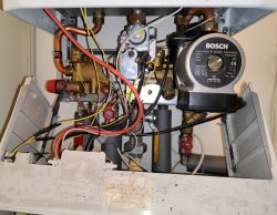 Interior of a boiler with visible pipes and Bosch pump.