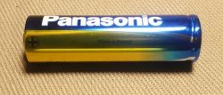 Panasonic battery on a beige background with the text Made in Poland.