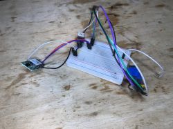 Woox WiFi module connected to a breadboard with wires.