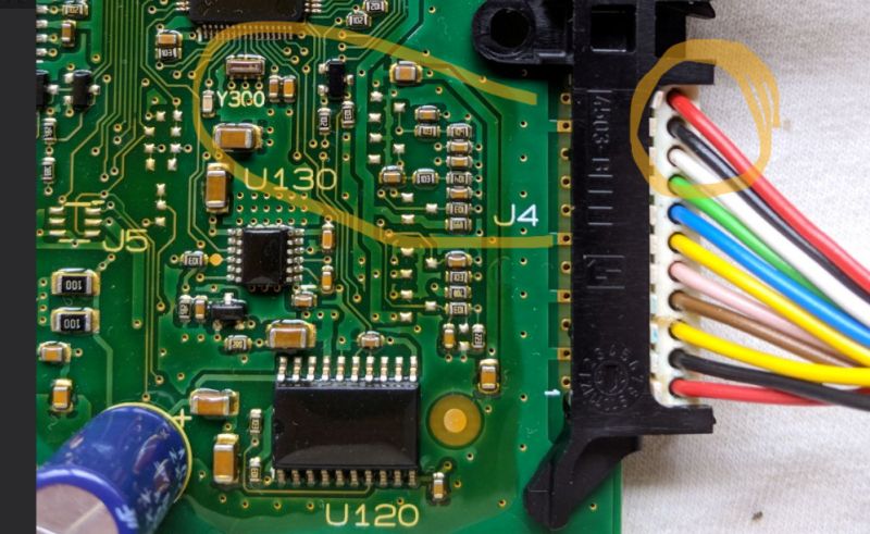 Image of a circuit board with a marked section and a bundle of wires.