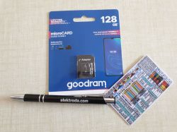 Goodram 128 GB microSD card with adapter, pen with elektroda.com printed, and a small cable color chart on a table.