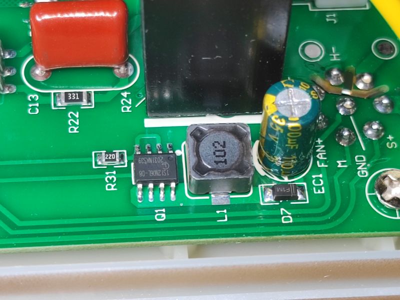 Close-up of Electronic Components on PCB Close-up of an electronic circuit on a green PCB with a capacitor, inductor, and integrated circuit.