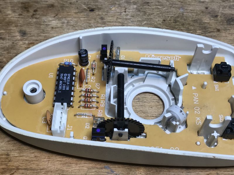 Interior of a Computer Mouse with Circuits and Mechanisms Interior of an old ball mouse without the ball