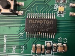 Nuvoton integrated circuit on a green printed circuit board with pins on both sides.