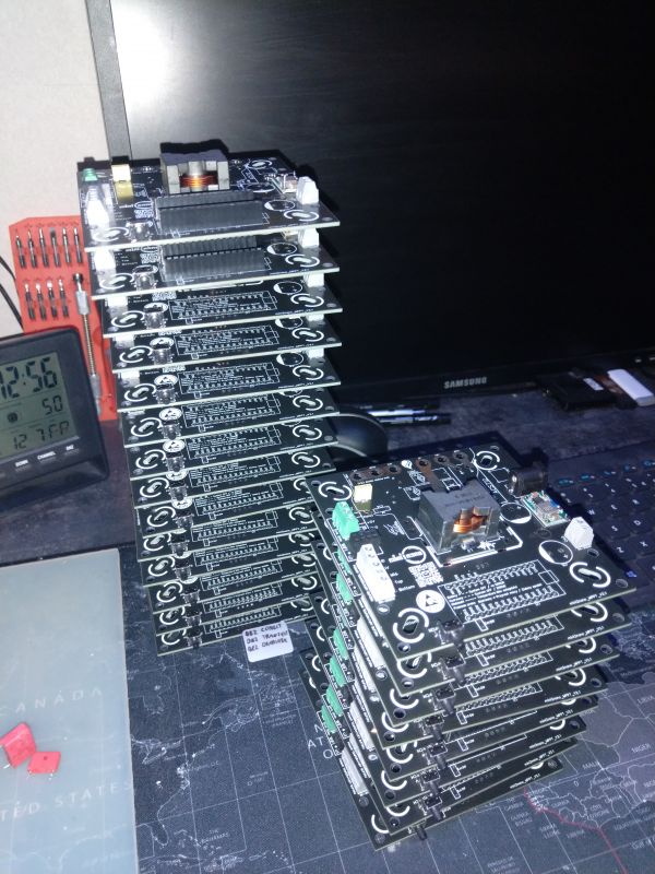 A stack of PCB boards on a desk, ready for component assembly.