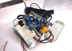 ATLO-GDC2-TUYA – Garage Door Controller Interior ATLO-GDC2-TUYA garage door controller with open casing, showing PCB with electronic components and wires.