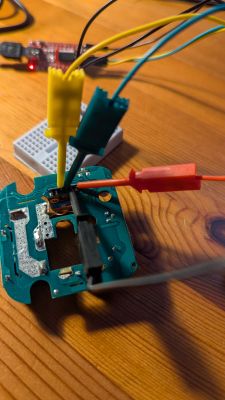 PCB connected with alligator clip wires on a wooden table