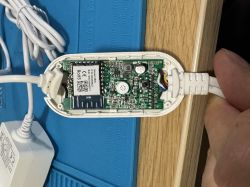 Opened electronic module with visible PCB board and connected wiring
