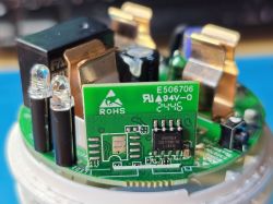 Inside View of Sonoff Smart Plug with CSE7759B Chip Close-up of a smart plug interior showing a PCB, two LEDs, and a Chipsea CSE7759B chip.