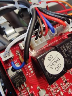Close-up of a circuit board with relays, wires, and connectors