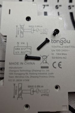 Close-up of Tongou electrical device housing with three black screws
