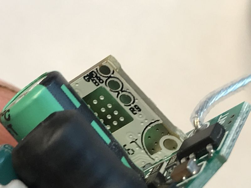 Programming Pads on WiFi LED PCB Close-up of a PCB with visible programming pads and module connector for WiFi.