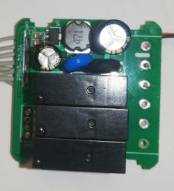 Dismantled Circuit Board with Three Relays Close-up of an open circuit board with three relays and capacitors.