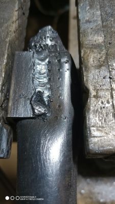 Weld on Metal Pipe Close-up of a weld on a metal pipe, showing signs of unevenness and cracks.