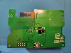 Close-up of an electronic board with labeled components, including two LEDs and a mounting hole.