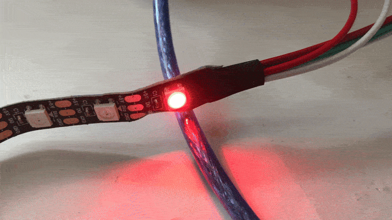 Flashing WS2812B LEDs on a Strip Flashing LED strip with WS2812B diodes connected to wires.