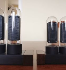 Comparison of two pairs of glass tubes with slightly different diameters on wooden bases