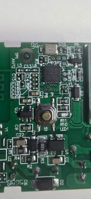 Close-up of PCB with BK7231N chip, button, and surrounding SMD components