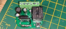 Electronic Module with Relay and Green Connectors Image of an electronic module with green connectors, a relay, and other components.